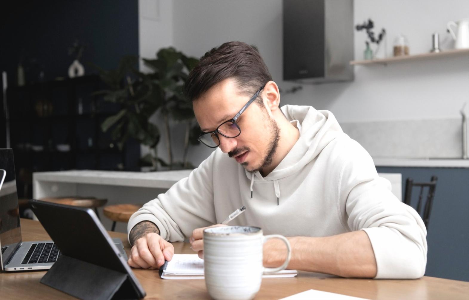 Students working on financial analysis project with laptops and documents